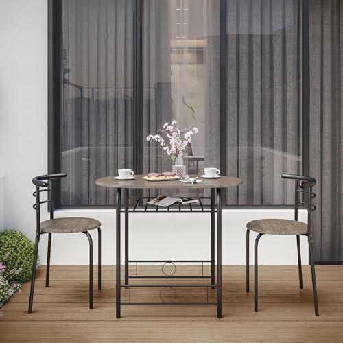 Outdoor bistro set with table, two chairs, and vase on patio.