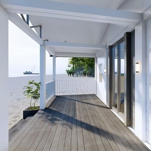 Sunny beachfront house porch with ocean view.