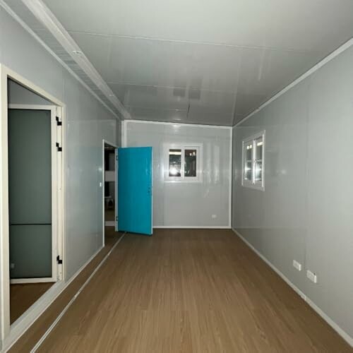 Empty room with wooden floor and blue door
