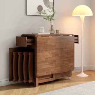 Wooden folding dining table with nested chairs and lamp.