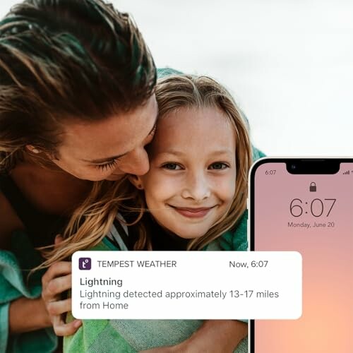 Mother and child with weather alert on phone.