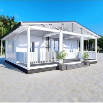 Modern white beach house with a porch on sandy beach.