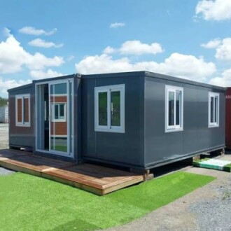 Modern container office with large windows and sliding door.