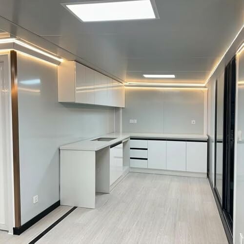 Modern kitchen interior with sleek white cabinets and LED lighting.
