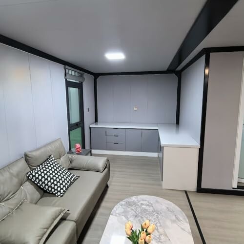 Modern living room with sofa, table, and built-in cabinets.