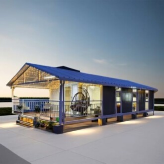 Modern prefabricated tiny house with large windows and lights.