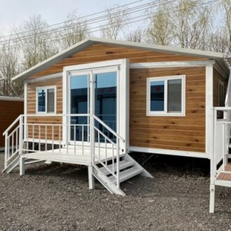 Modern tiny house with wooden siding and white trim.