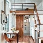 Modern tiny house interior with loft and wooden accents.