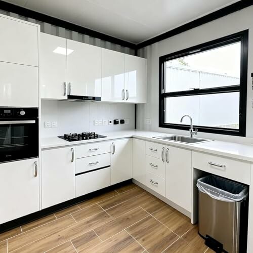 Modern white kitchen with appliances and wooden floor
