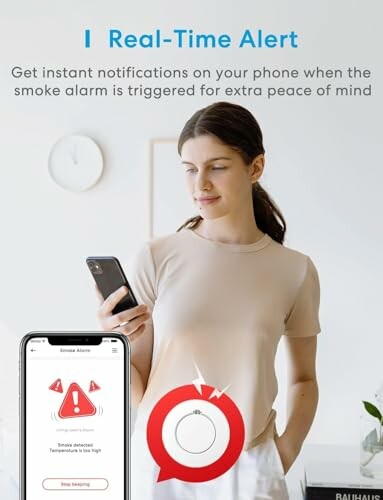 Woman receiving smoke alarm notification on phone.