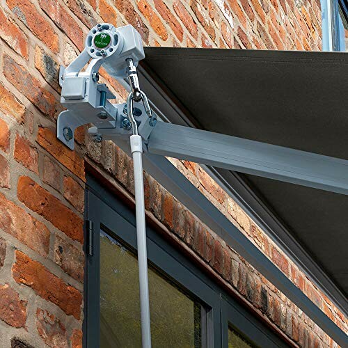 Retractable awning mounted on brick wall.