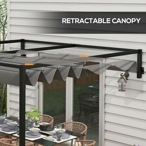 Retractable canopy over a patio with a dining set.