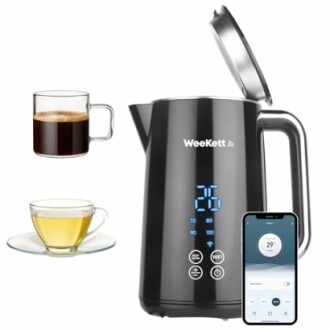 Smart electric kettle with temperature display and app control, next to coffee and tea cups.