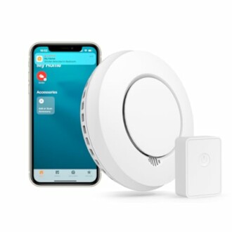 Smart home device kit with smartphone, smoke detector, and power adapter.